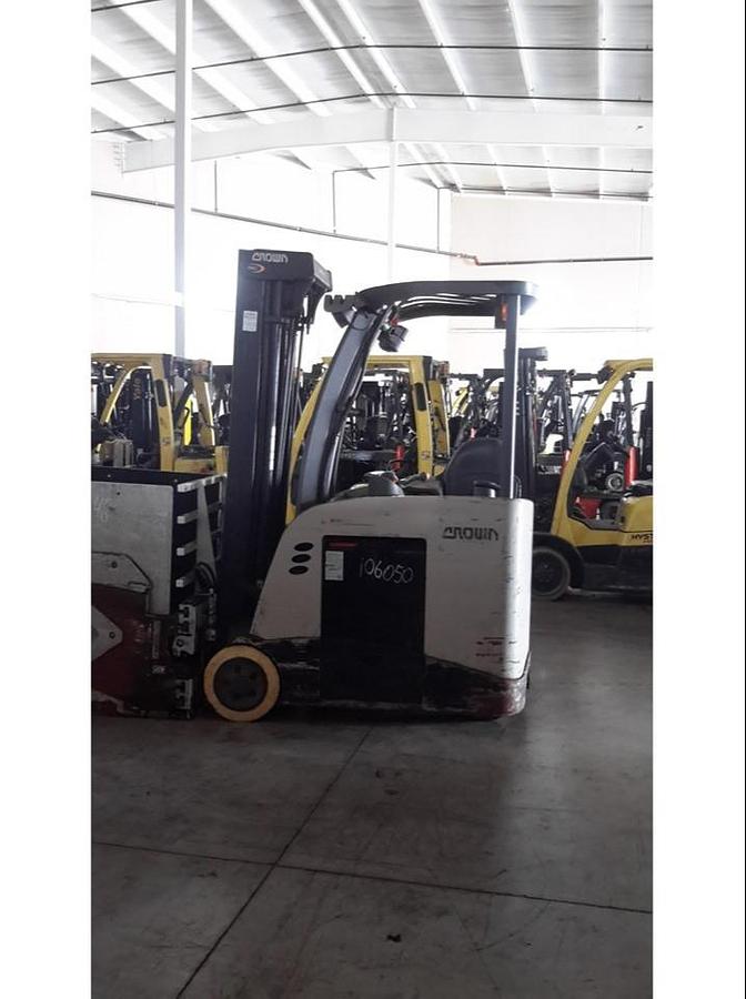 Opposite side view of refurbished 2014 Crown RC5545‑40 electric forklift showing operator compartment, 3‑stage mast, 4‑way hydraulics, 36 volt battery compartment, and CSA certification decal during Ontario deployment.