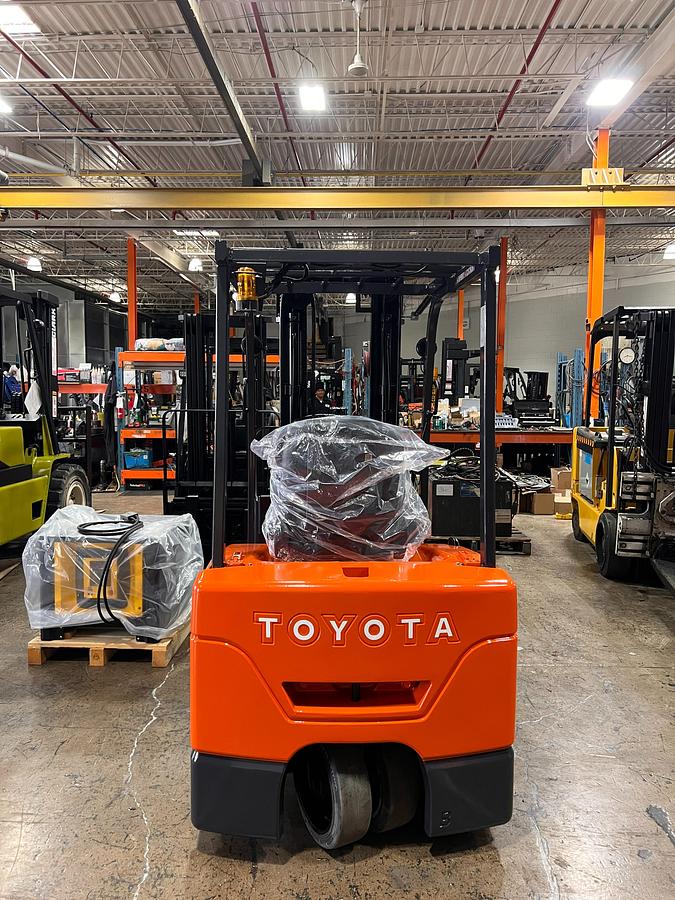 Rear view of Toyota 7FBEU18 electric forklift highlighting counterweight, safety decals, and CSA certification during warehouse deployment