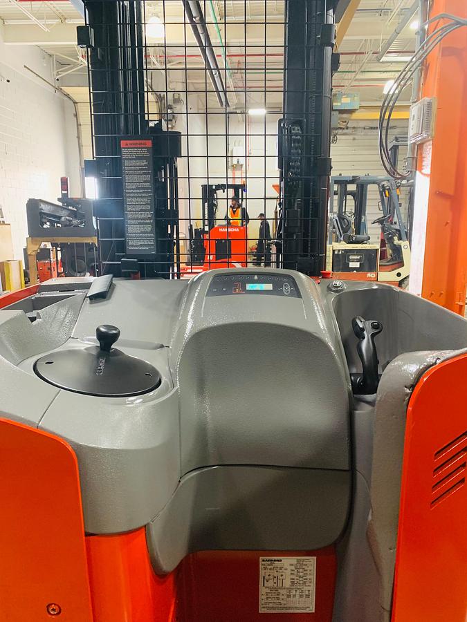 Operator compartment view showing ergonomic deck and forward stance controls