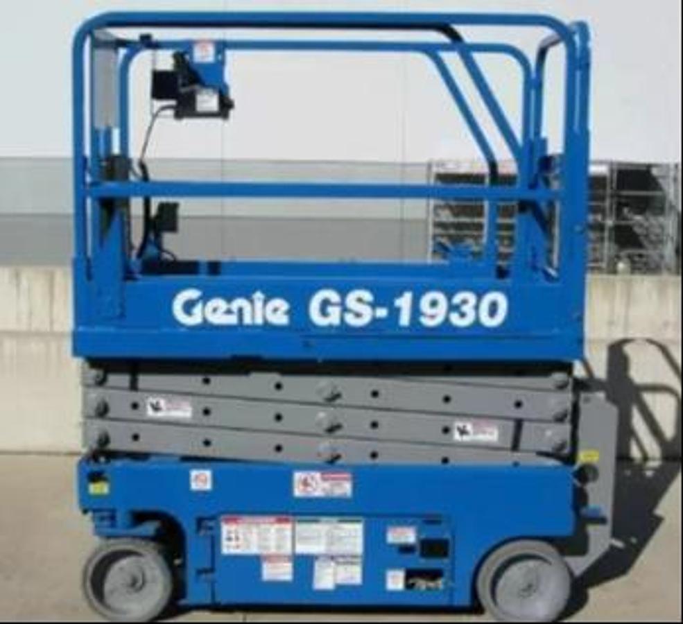 Side view of brand‑new 2025 Genie GS‑1930 electric scissor lift, 19 ft platform height, narrow slab design, CSA certified.