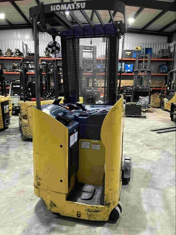 Rear view of Komatsu FR15K‑3 double reach truck showing stand‑up operator compartment and chassis design.