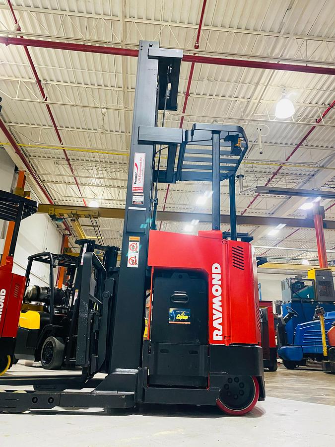 Side view of Budget Raymond reach truck — mast, chassis, and reach mechanism