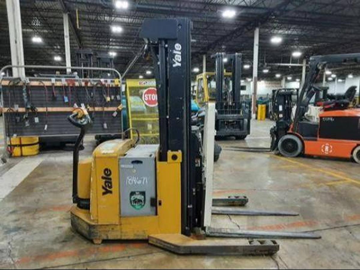 Side view of refurbished 2011 Yale MR03030 electric walkie reach stacker showing mast rails, CSA decal, and 42" forks during Ontario deployment