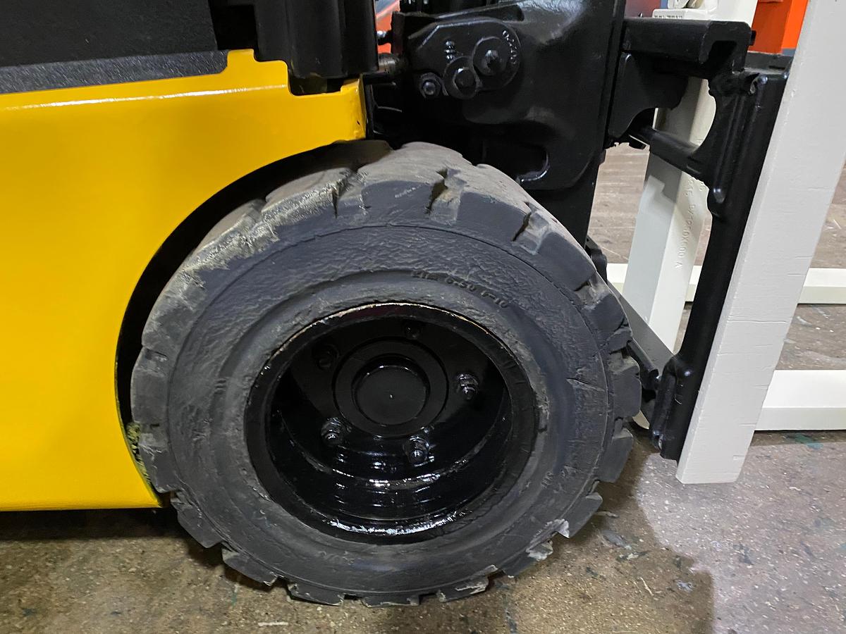 Right solid pneumatic drive tire showing tread pattern and CSA spec