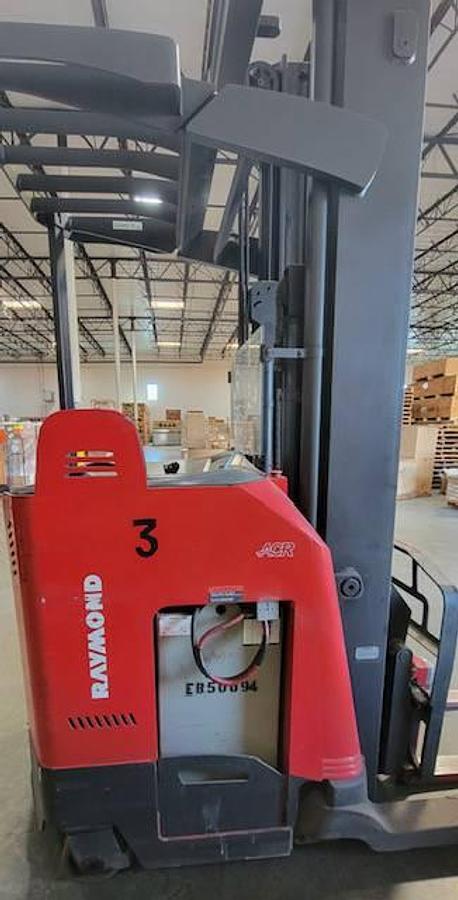 Opposite side profile of refurbished 2007 Raymond 740DR32TT electric deep-reach forklift showing 252" triple mast, reach carriage, and narrow aisle chassis during Brampton deployment