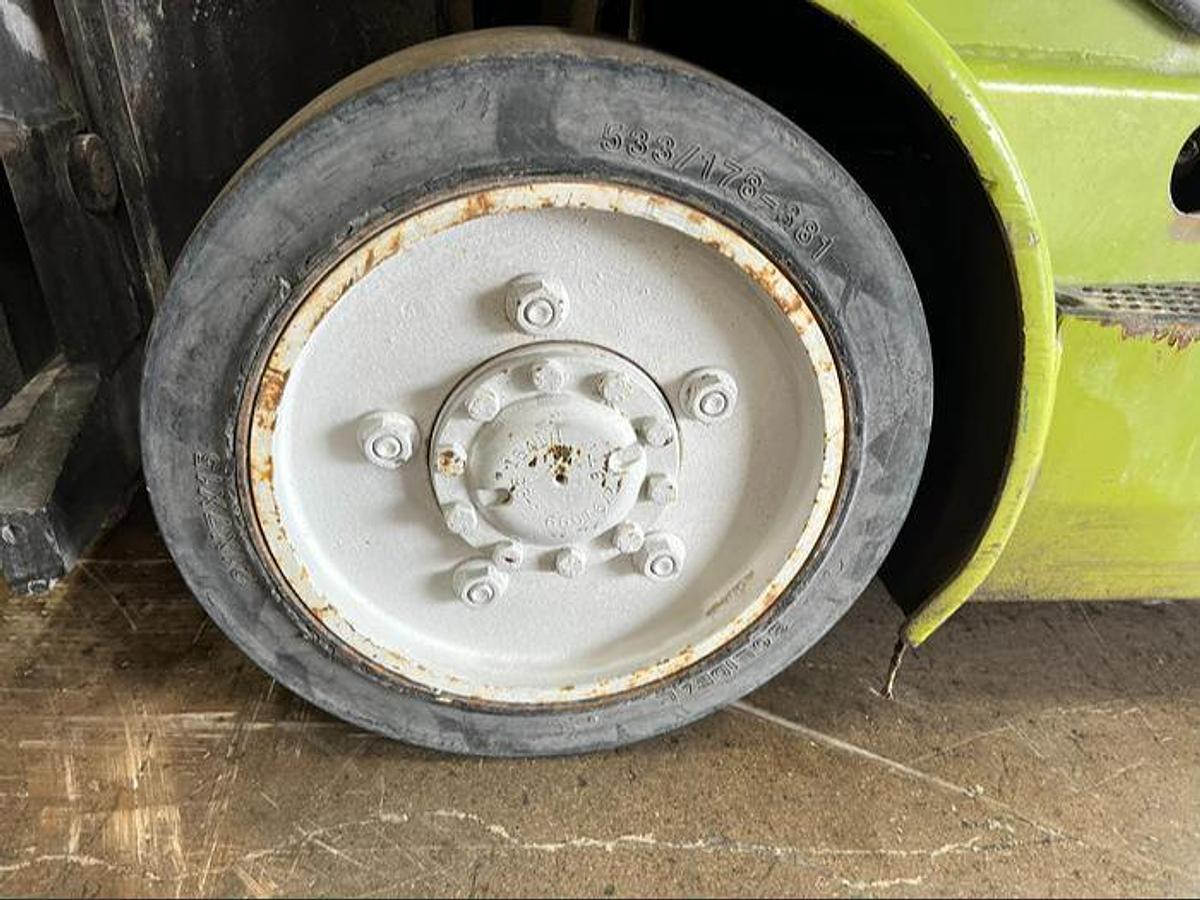 Left drive tire of Budget Clark CGC25 older LPG cushion forklift, non‑CSA.