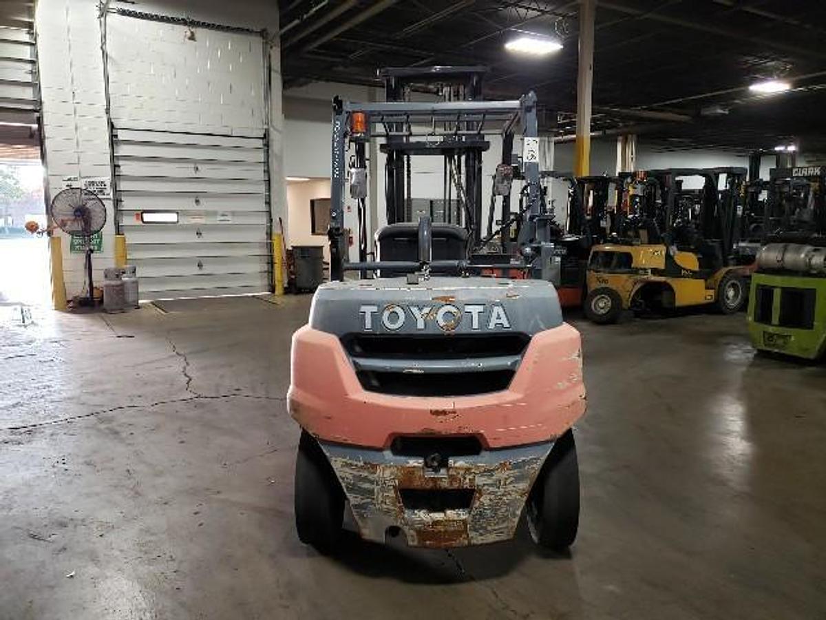 Rear view of Toyota 8FG35U forklift showing counterweight, LPG tank mount, and chassis