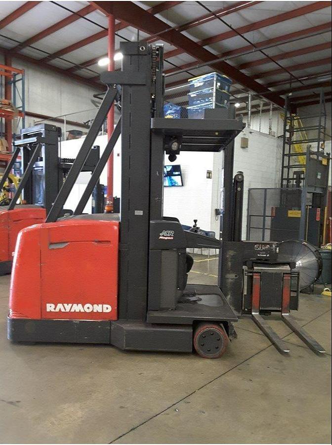Opposite  side view of refurbished 2012 Raymond 960-CSR30TT electric man-up turret truck showing safety rails, battery compartment, and rear frame during Ontario deploymen