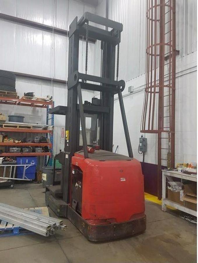 Rear angle side view of refurbished 2006 Raymond electric man-up turret truck showing operator platform, control panel, and rear chassis during Ontario deployment