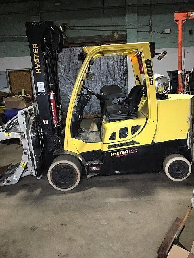 Side profile of 2015 Hyster S120FTPRS LPG cushion forklift showing mast rails, chassis layout, and indoor tires during Brampton deployment