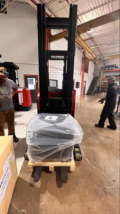 Front angled view showing mast rails, 42” fork tips and charger