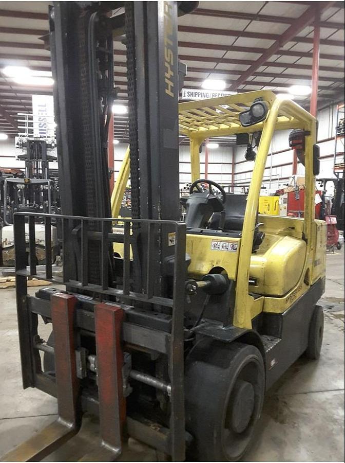 Head-on view of refurbished 2012 Hyster S155FT diesel cushion forklift showing 2-stage mast, 60" forks, fork positioner, and operator cab during Brampton deployment