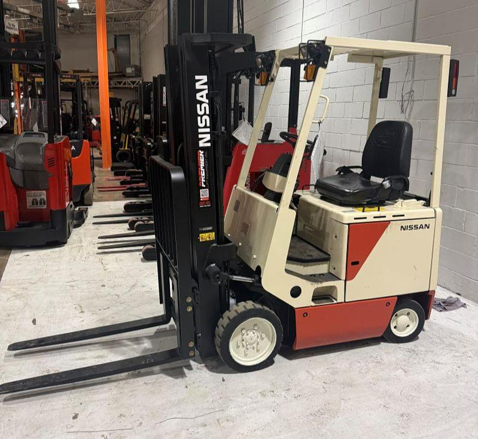 Refurbished Nissan CUM01L15SN 3000 lb electric cushion forklift side view with 83/187 triple mast and side shift