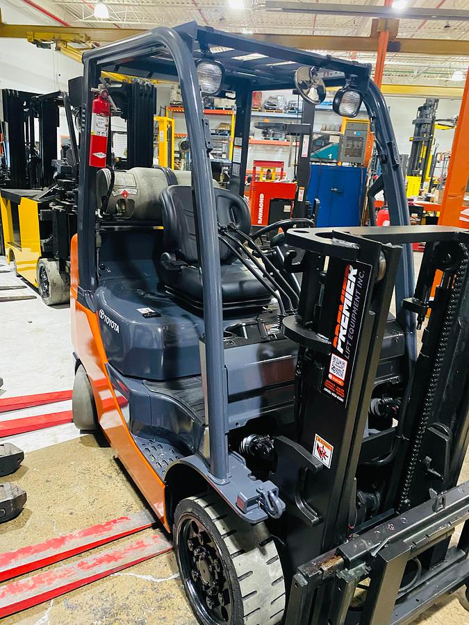 Angle from rear of 2011 Toyota 8FGCU20 propane forklift – CSA-certified 4,000 lb cushion tire chassis with 189” mast, propane tank mount, and rear safety decals shown reconditioned and ready for CSA deployment, Brampton ON – Premier Lift Equipment