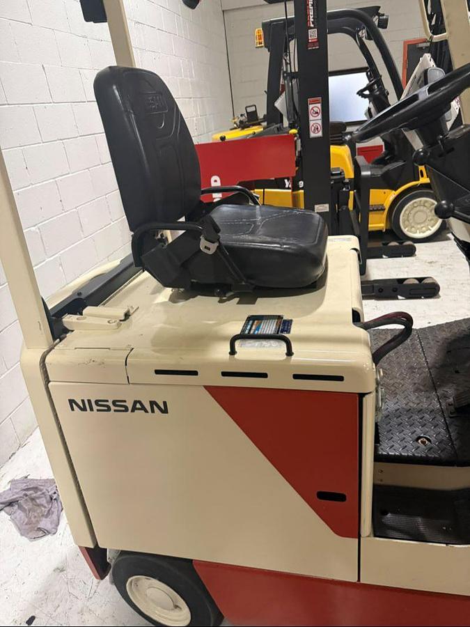 Nissan CUM01L15SN electric forklift operator compartment with seat, controls, and steering column