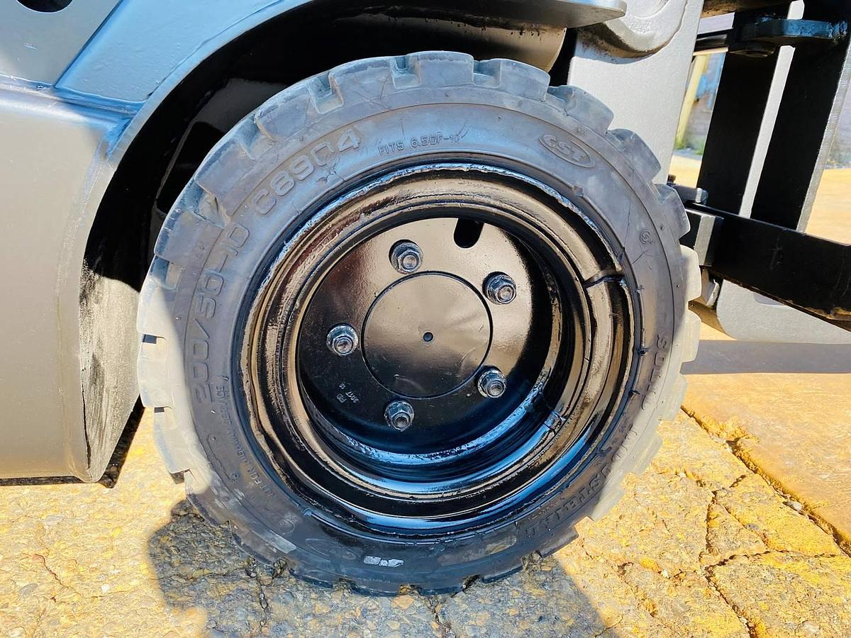 Solid pneumatic drive tire of refurbished 2018 EP Equipment CPD20 3‑wheel electric forklift showing tread detail, rim assembly, and CSA certification decal during Brampton deployment.