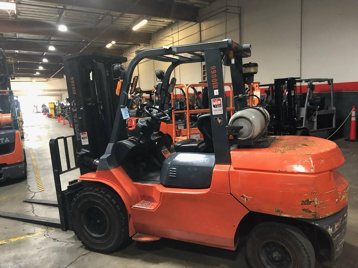 Opposite side view of refurbished 2013 Toyota 7FGU45 LP gas forklift showing rear chassis, propane tank mount, and CSA decal during Brampton deployment
