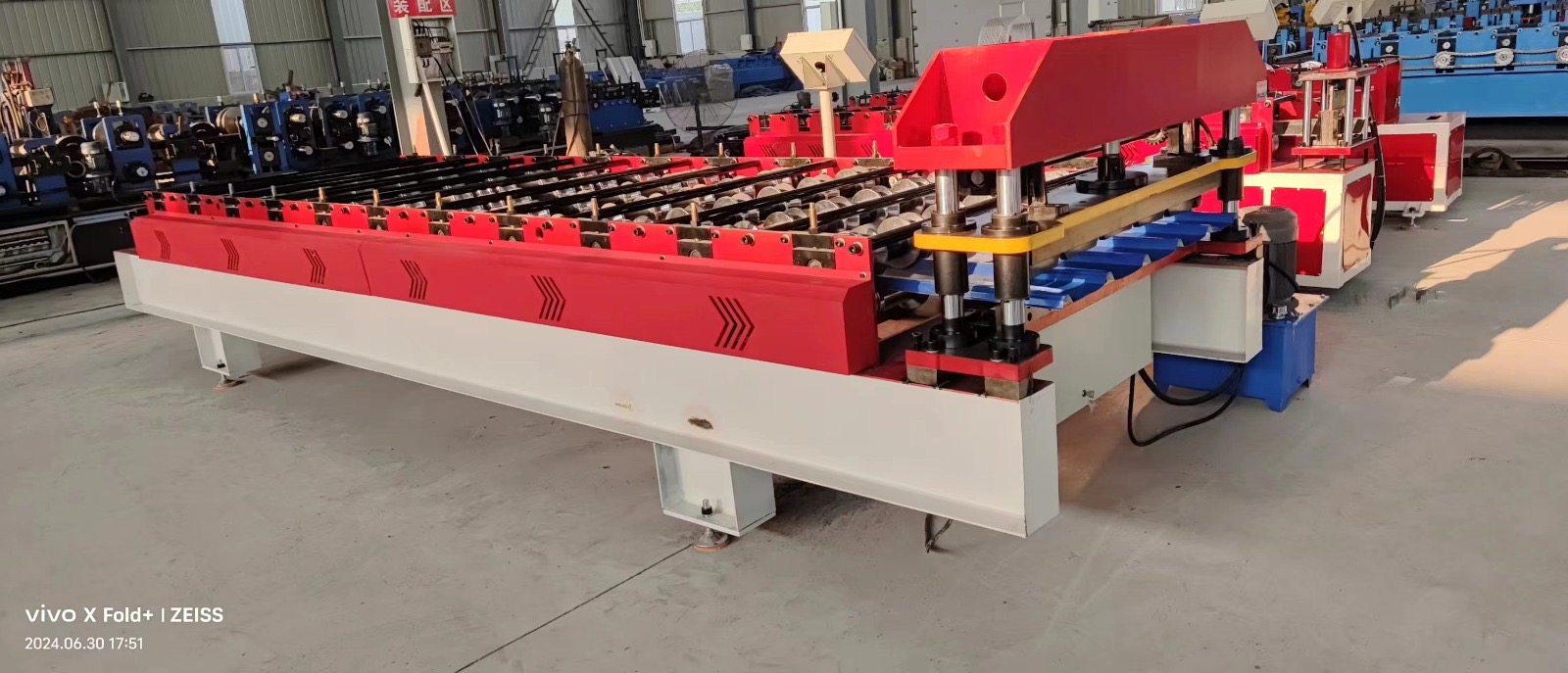 Machine for forming metal roof or wall panels