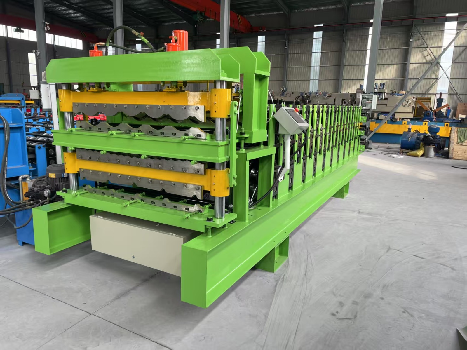 Machine for forming metal roof or wall panels