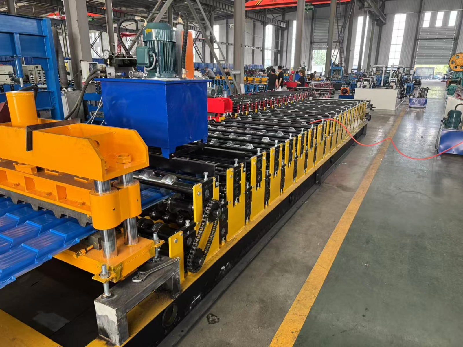 Machine for forming metal roof or wall panels