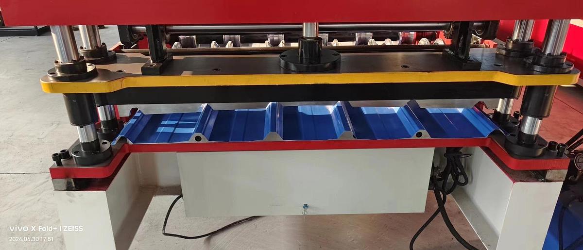 Machine for forming metal roof or wall panels