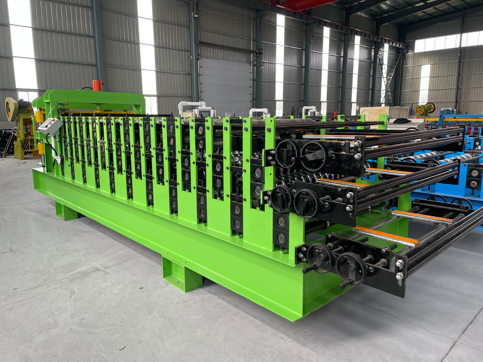 Machine for forming metal roof or wall panels