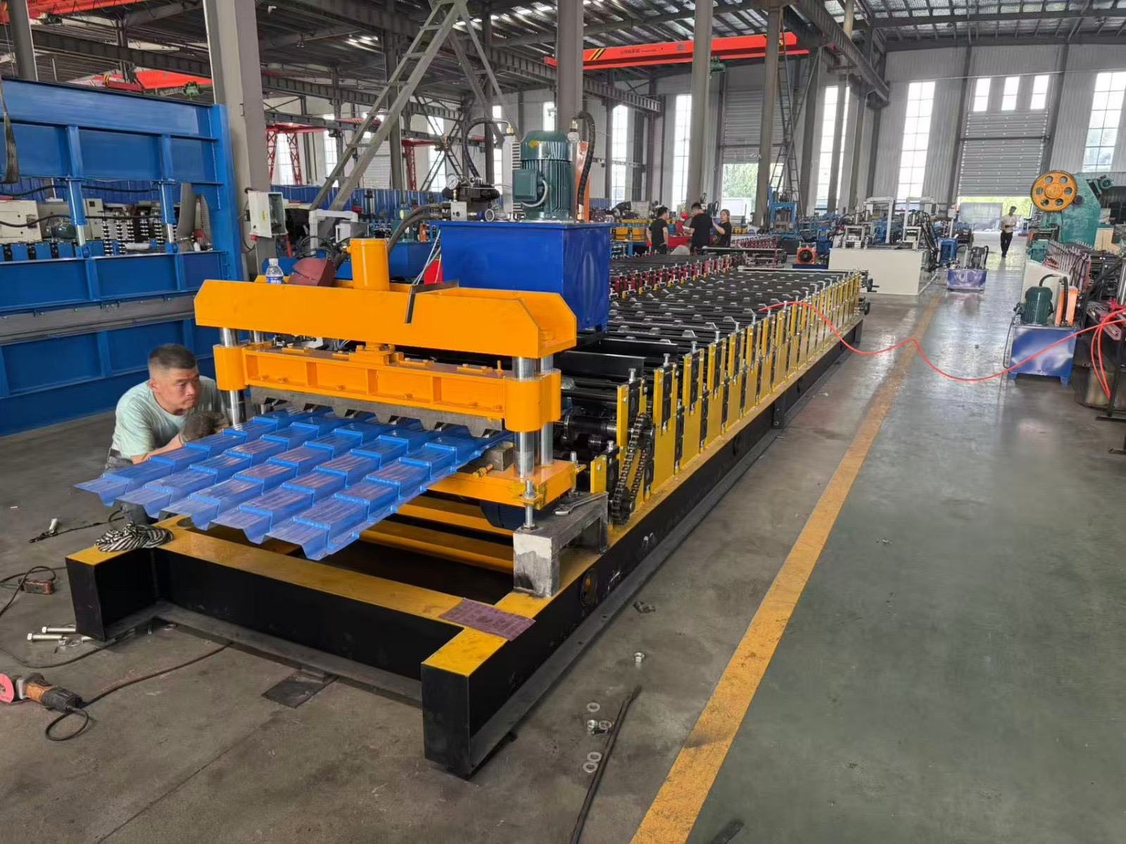 Machine for forming metal roof or wall panels
