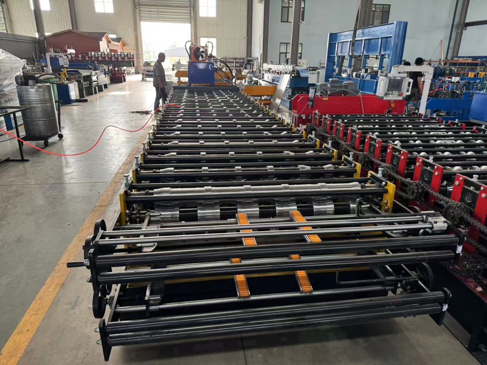 Machine for forming metal roof or wall panels