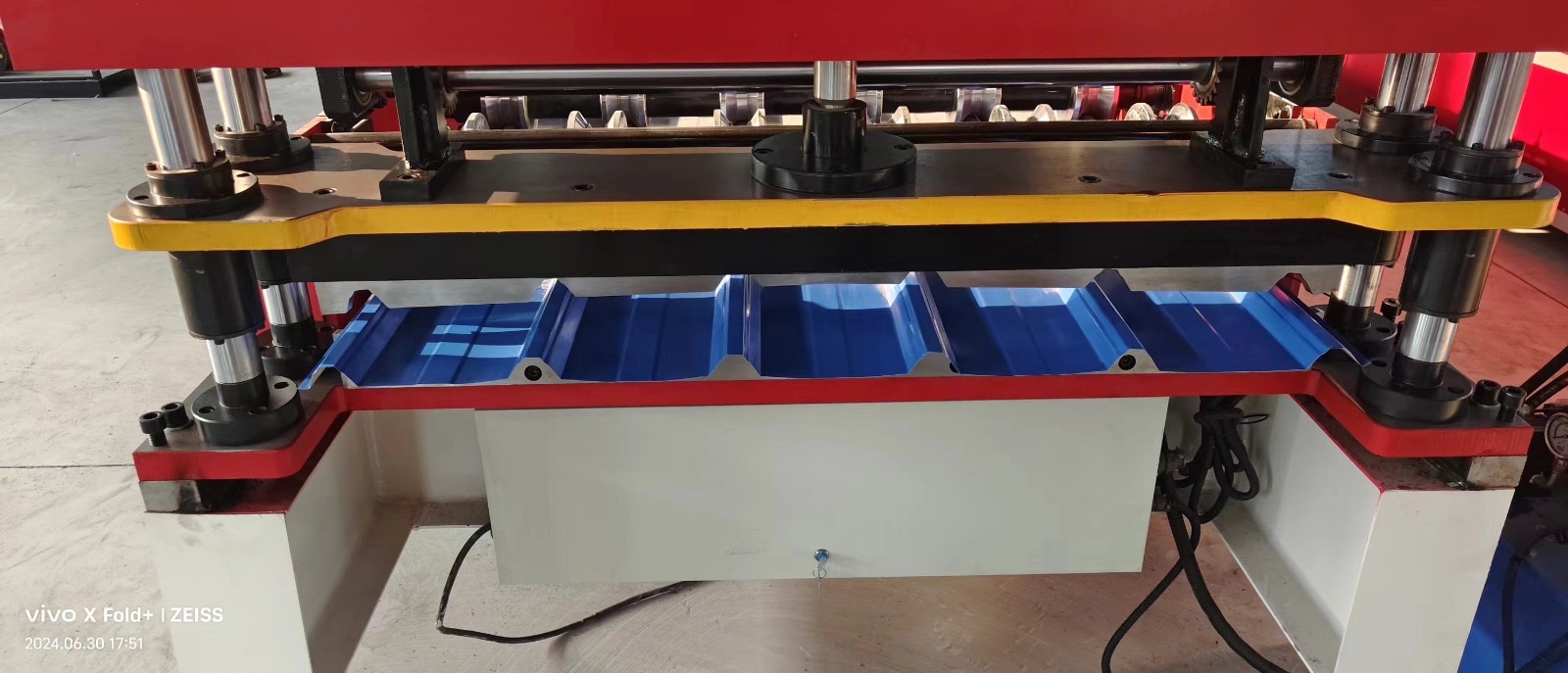 Machine for forming metal roof or wall panels