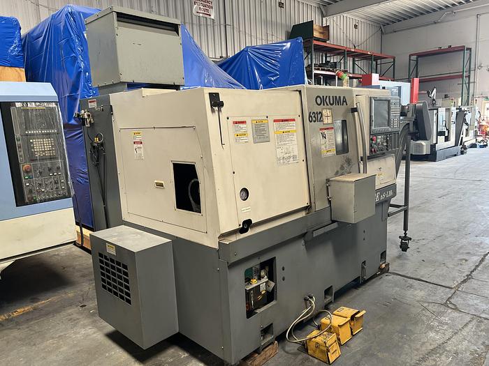 Used 2010 OKUMA Heritage ES-L10II CNC Turning Center With Edge Rebel 102 Bar Feeder