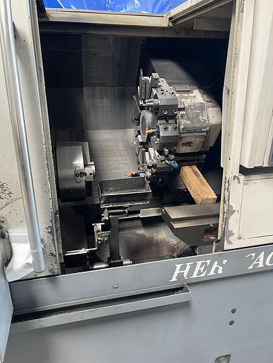 Used 2010 OKUMA Heritage ES-L10II CNC Turning Center With Edge Rebel 102 Bar Feeder