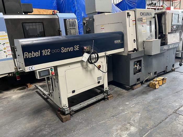 Used 2010 OKUMA Heritage ES-L10II CNC Turning Center With Edge Rebel 102 Bar Feeder