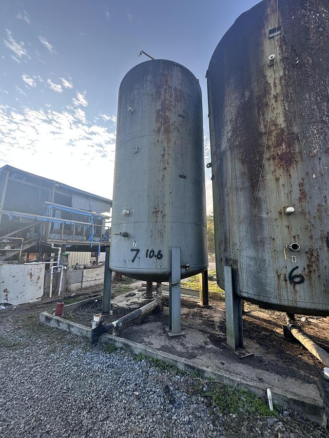 Used (2) Used approximately 10,600 gallon vertical carbon steel storage tanks