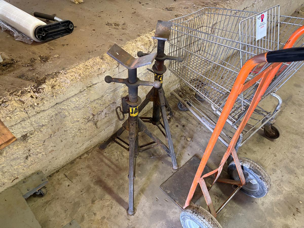 Used (2) adjustable height pipe stands, (1) 2-wheel dolly, & (1) shopping cart