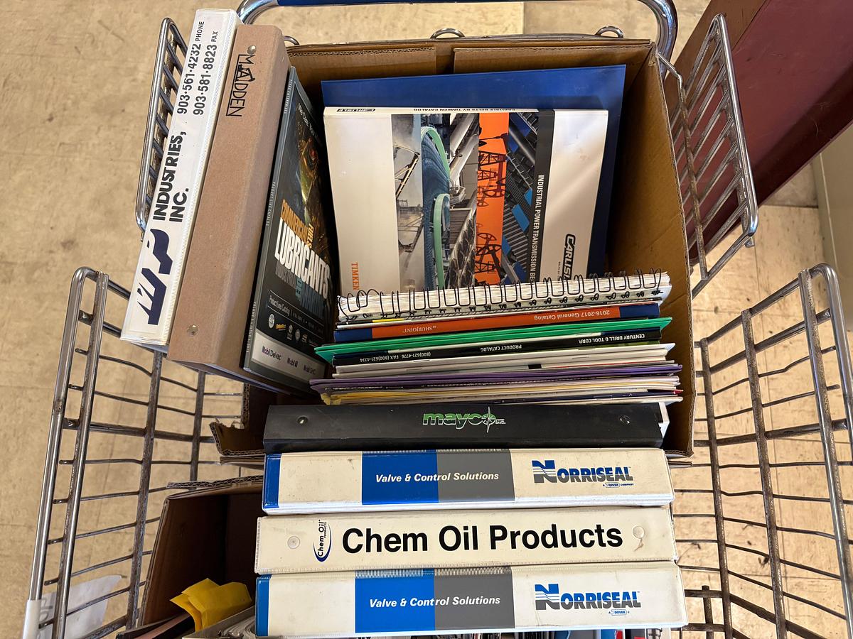 Used Shopping cart full of assorted oilfield equipment catalogs