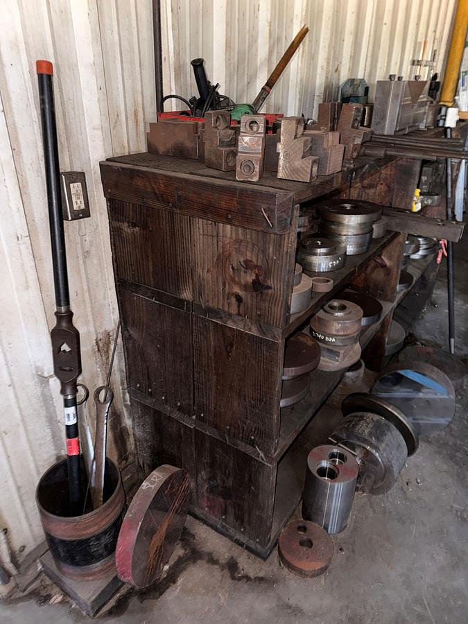 Used WALL W/ 3-ROW WOOD SHELF & CONTENTS OF MILLING MACHINE FIXTURES, ADAPTERS, & RELATED