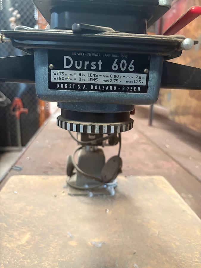 Used 10’ x 57” x 3’ shop table W/ durst 606 drill press, 4-drawer filing cabinet, & 90” x 45” storage rack