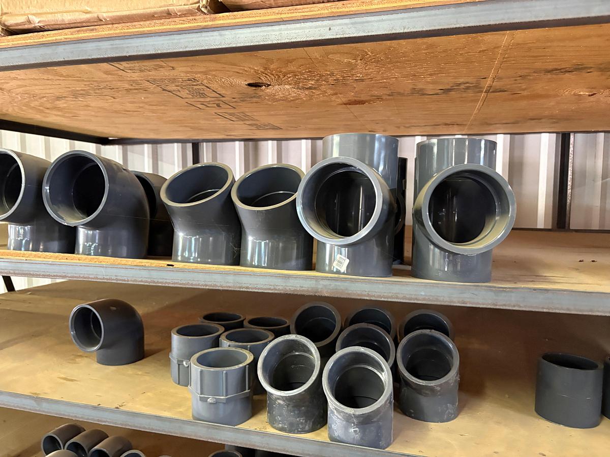 Used Contents of (5) shelves w/ U-line oil spill pads, various 2” to 4” PVC pipe fittings, etc.