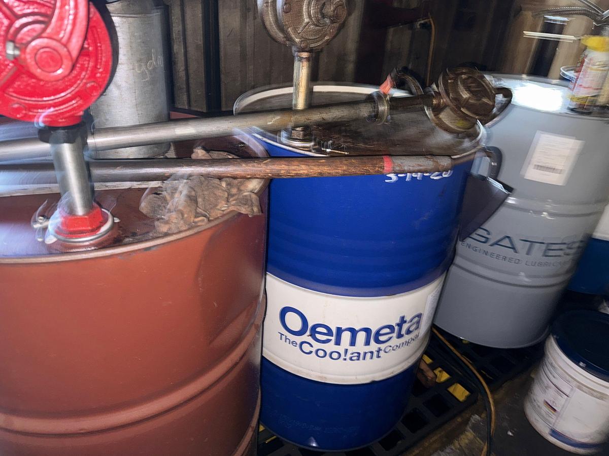 Used SECTION W/ 4- 55 GAL DRUMS & 5-Gal Pails MOSTLY FULL OF MACHINING COOLING LUBRICANTS W/ HAND PUMPS & CATCH PANS