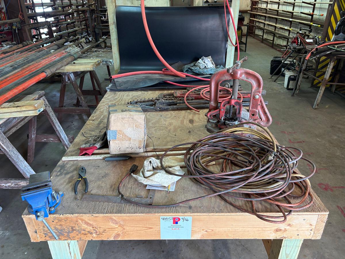 Used 8’ x 4’ x 8’ wooden shop table W/ bench vise, pipe vise, built in spool rack, 9/16” to 1-1/8” rubber hose, extension cords, etc