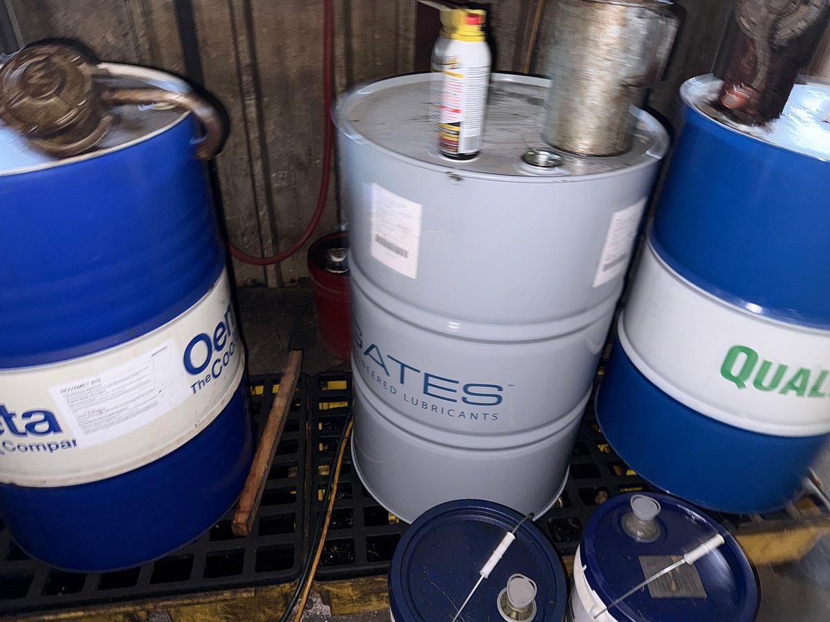 Used SECTION W/ 4- 55 GAL DRUMS & 5-Gal Pails MOSTLY FULL OF MACHINING COOLING LUBRICANTS W/ HAND PUMPS & CATCH PANS
