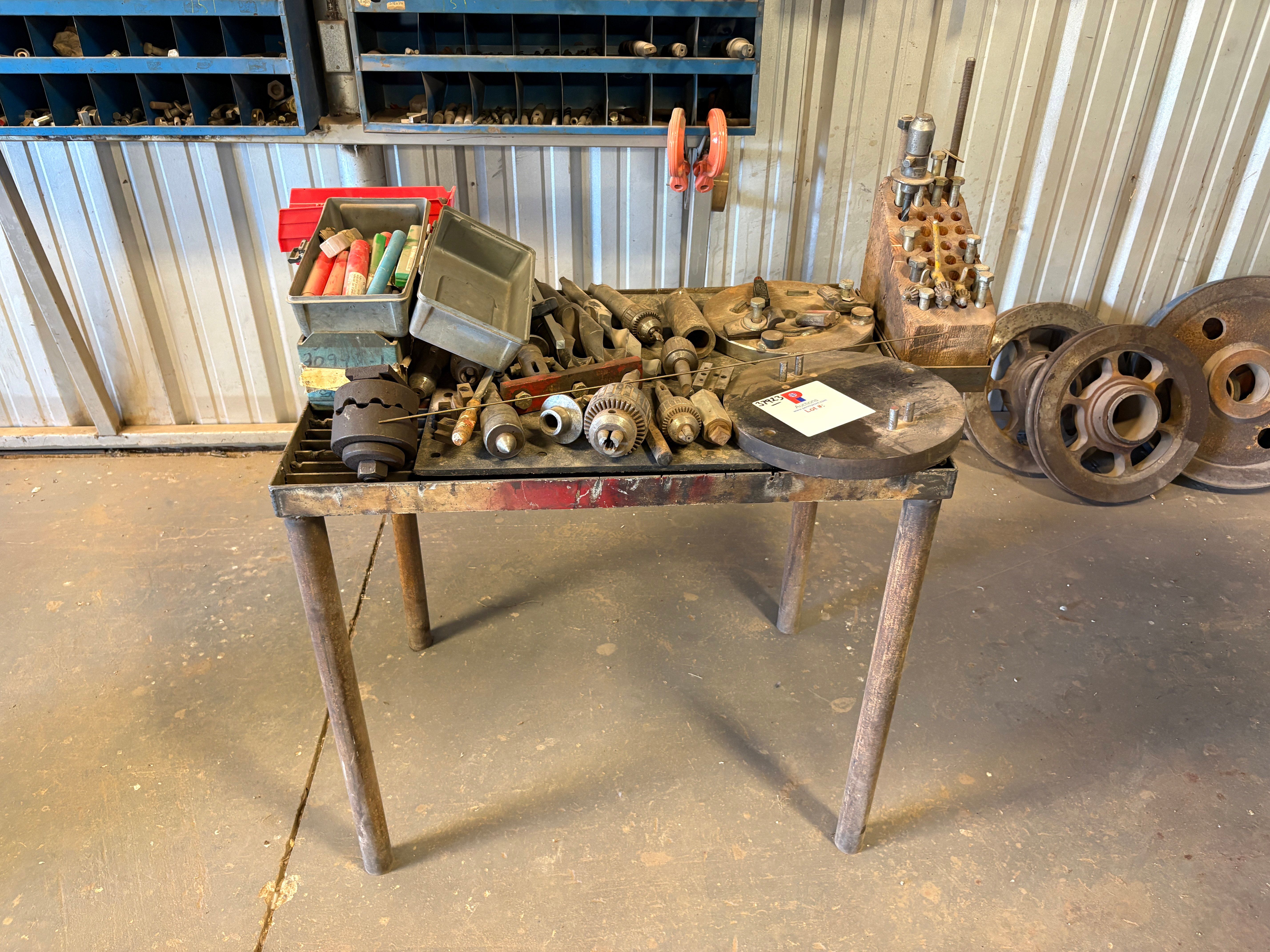 Used 37” x 26” x 34” table w/ assorted drill press chucks, drill bits, tap & dies, & assorted bolts