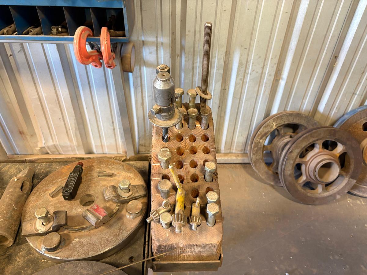 Used 37” x 26” x 34” table w/ assorted drill press chucks, drill bits, tap & dies, & assorted bolts