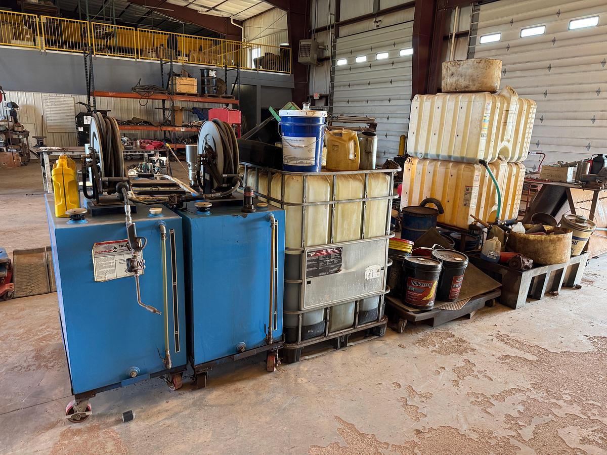 Used LOT W/ (2) 150-GALLON STEEL ROLLING OIL TANKS W/ AIR PUMPS, GUNS, & HOSES, (HAS SOME FLUID), (3) ROLLING LUBE BBLS, & RELATED