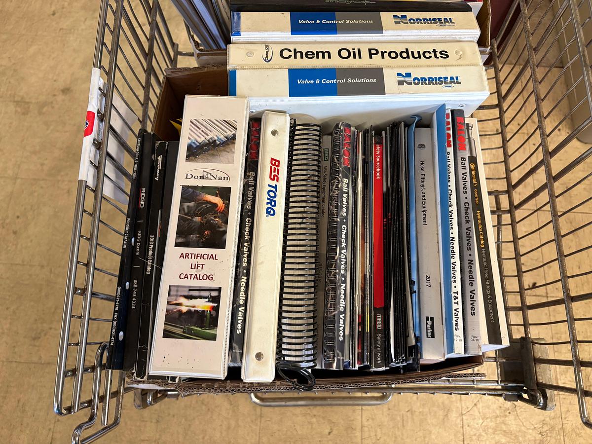 Used Shopping cart full of assorted oilfield equipment catalogs