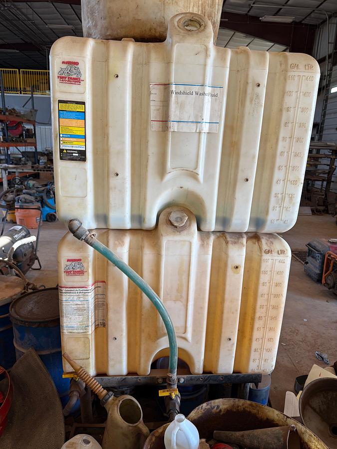Used LOT W/ (2) 150-GALLON STEEL ROLLING OIL TANKS W/ AIR PUMPS, GUNS, & HOSES, (HAS SOME FLUID), (3) ROLLING LUBE BBLS, & RELATED