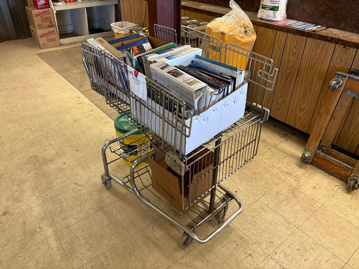 Used Shopping cart full of assorted oilfield equipment catalogs