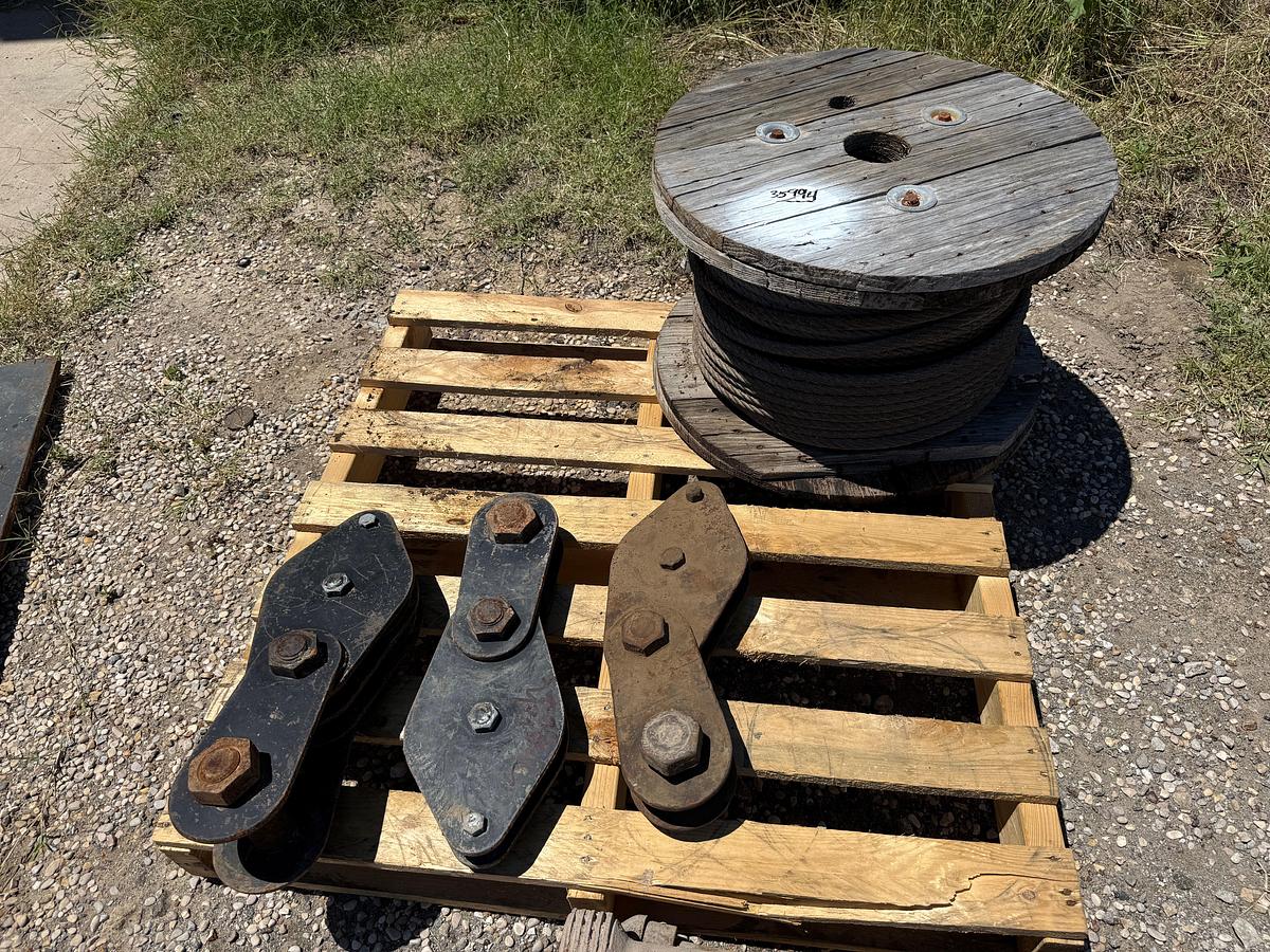 Used PALLET W/ (3) SNATCH BLOCKS & (1) SPOOL OF 1/2” WIRE ROPE