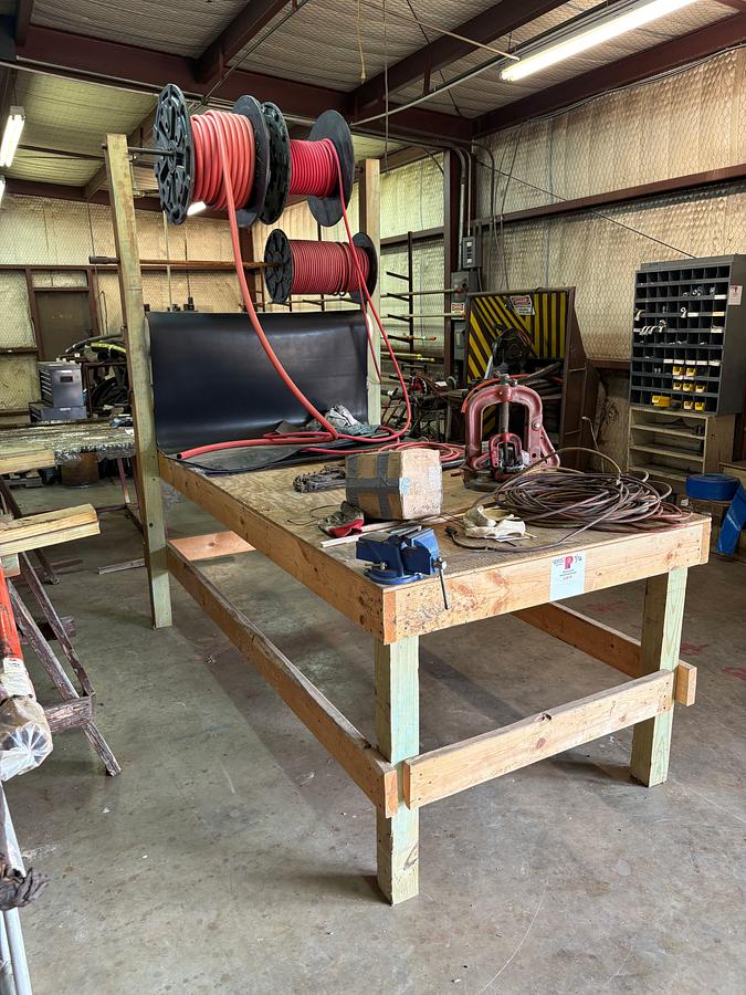Used 8’ x 4’ x 8’ wooden shop table W/ bench vise, pipe vise, built in spool rack, 9/16” to 1-1/8” rubber hose, extension cords, etc