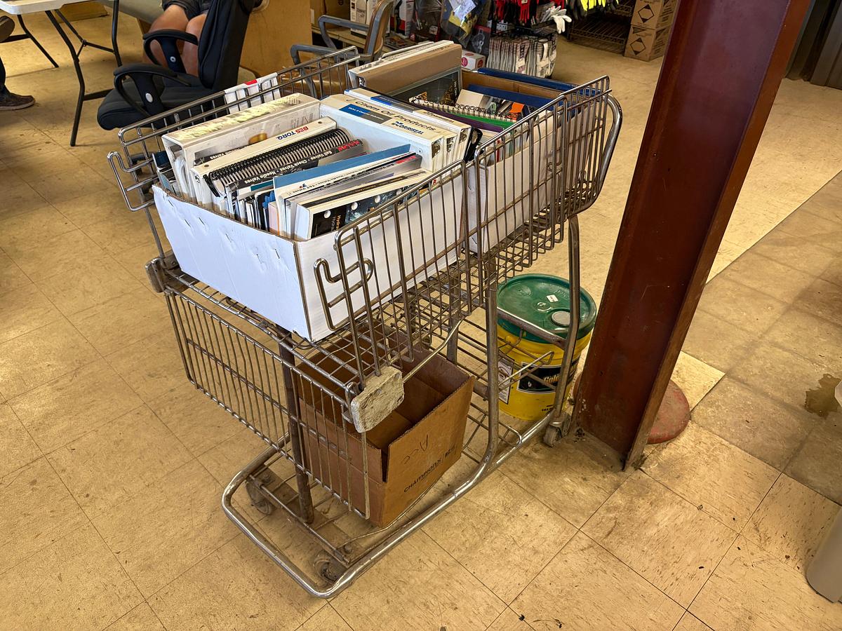 Used Shopping cart full of assorted oilfield equipment catalogs